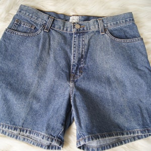 May include: A pair of blue denim shorts with a button and zip fastening. The shorts have five pockets and a classic fit.