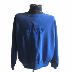 May include: A blue sweatshirt with a white embroidered logo that says "Import Export G.T.M.O. Collection".