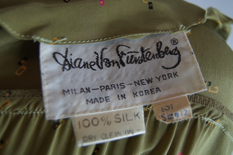 May include: A white tag with black text that reads "Diane Von Furstenberg", "Milan-Paris-New York", "Made in Korea", "100% Silk", and "Lot Size 12".