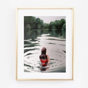 May include: A framed painting of a woman in a red swimsuit swimming in a lake. The water is calm and the woman is facing away from the viewer. The background is a green forest.