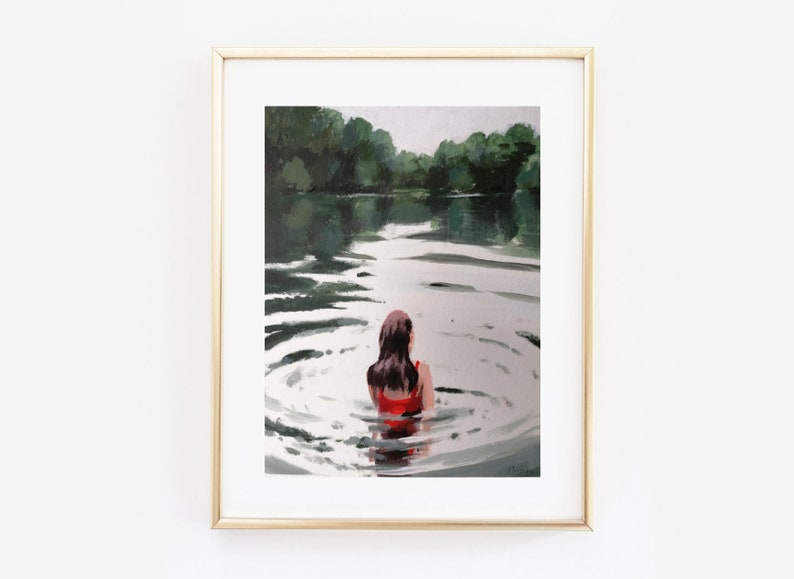 May include: A framed painting of a woman in a red swimsuit swimming in a lake. The water is calm and the woman is facing away from the viewer. The background is a green forest.