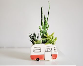 Small orange vintage camper planter