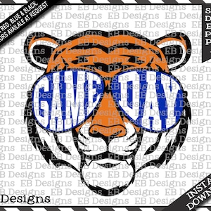 May include: A cartoon tiger wearing blue sunglasses with the word "GAME DAY" spelled out in white letters. The tiger's fur is orange and black.