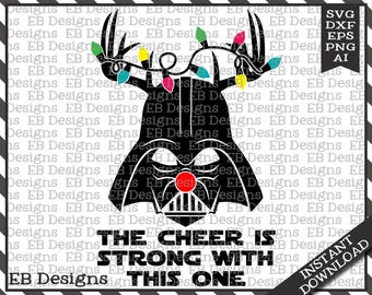 May include: Black and white digital design featuring Darth Vader's helmet with reindeer antlers and Christmas lights. The text reads "The Cheer Is Strong With This One." Includes SVG, DXF, EPS, PNG, and AI file formats.