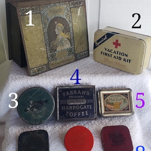 May include: Collection of vintage tins and containers. Includes a large rectangular tin with a woman's portrait, a small first aid kit, a Farrah's Harrogate Toffee tin, and other small, round and square tins.