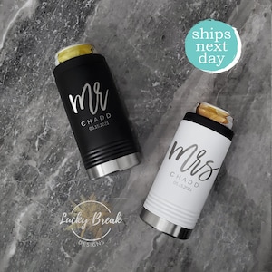 May include: Two black and white insulated beverage holders with the words "Mr. CHADD 08.15.2021" and "Mrs. CHADD 08.15.2021" printed on them.