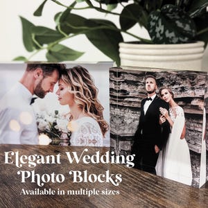 May include: Two clear acrylic photo blocks with wedding photos. The first block shows a couple looking at each other, the second block shows a couple standing in front of a rocky cliff.  Elegant Wedding Photo Blocks. Available in multiple sizes.