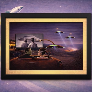 May include: Framed artwork depicting a vintage drive-in movie scene with a classic car, the Frankenstein monster, and his bride. Flying saucers and a rocket ship add a retro sci-fi element. The artwork is framed in black with a gold inner border.