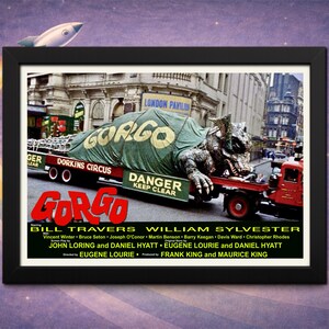 May include: A framed movie poster for the film "Gorgo" featuring a large monster on a flatbed truck in a city. The poster has a black frame and includes the film's title and cast.