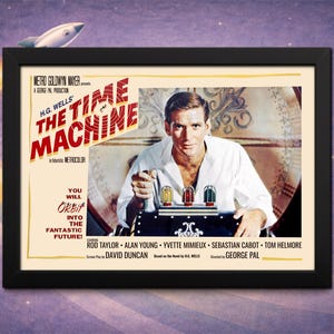 May include: A framed movie poster for "The Time Machine" featuring Rod Taylor. The poster has a black frame and a vintage design with the film's title in bold red letters. A rocket ship graphic is at the top.