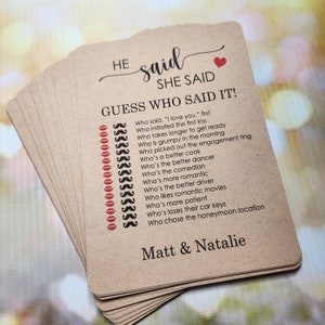 May include: A brown card game with the text "HE said SHE SAID GUESS WHO SAID IT!" and a list of questions about a couple's relationship. The card also includes the names "Matt & Natalie".