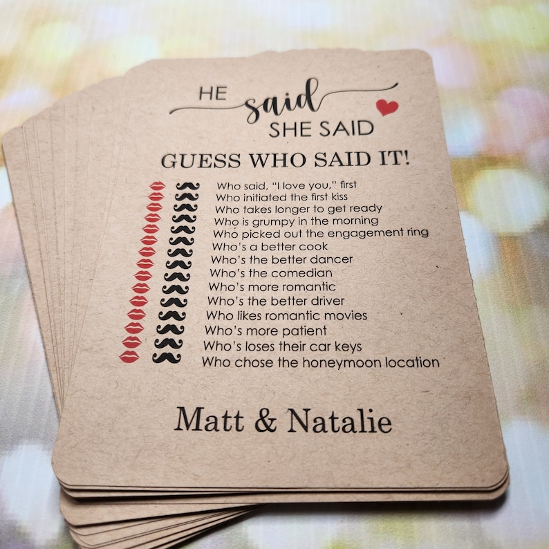 May include: A brown card game with the text "HE said SHE SAID GUESS WHO SAID IT!" and a list of questions about a couple's relationship. The card also has the names "Matt & Natalie" at the bottom.