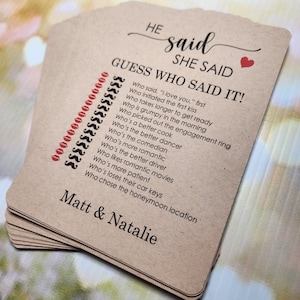 May include: A brown card game with the text "HE said SHE SAID GUESS WHO SAID IT!" and a list of questions about a couple. The card also has the names "Matt & Natalie" printed on it.