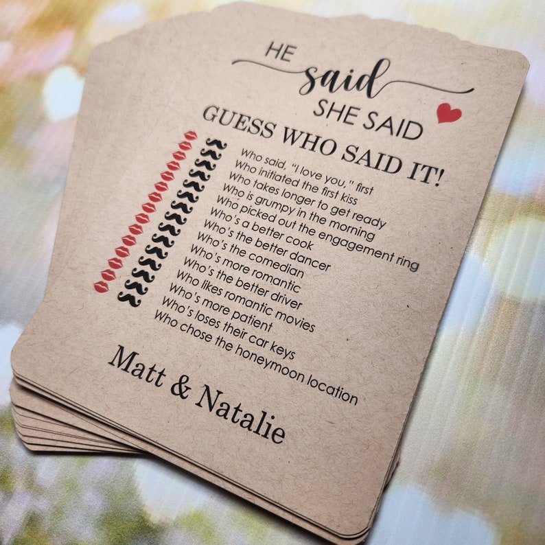 May include: A brown card game with the text "HE said SHE SAID GUESS WHO SAID IT!" and a list of questions about a couple. The card also has the names "Matt & Natalie" printed on it.