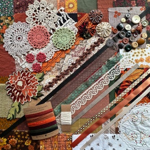 May include: A collection of fabric scraps, lace, ribbon, and buttons in shades of brown, green, and white. The fabric scraps are arranged in a patchwork pattern and include a variety of textures, including lace, burlap, and velvet. The buttons are a mix of colours and sizes, and some have a floral design. The text "Uniquely Orchard" is visible on a brown tag.