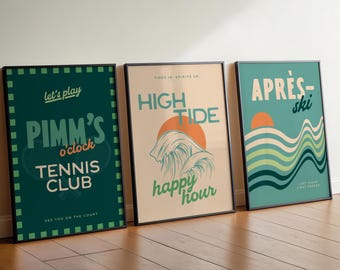 May include: Three framed art prints with black borders. The left print is green with white text: "Pimm's o'clock Tennis Club." The middle print is beige with orange and teal text: "High Tide happy hour." The right print is teal with orange text: "Après-ski."