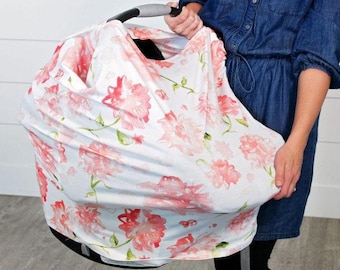 May include: A white car seat cover with a pink floral pattern. The cover is made of a soft, breathable fabric and is designed to protect your car seat from spills, dirt, and wear and tear.