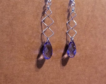 Lavender Swarovski briolette  drops are suspended on sterling silver woven wire producing a 2 inch drop.  The elegance enhanced with silver.