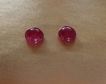 These Ruby cabochons from Burma are raspberry pink, 3 carats each, and they measure 9mm round.  Opaque with translucence and silk.