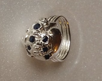 Here is a precious metal (.999 pure silver) dome ring that is classy and comfortable.  Natural sapphires.  Perfect for every day wear.