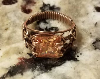 Red Bronze wraps a dark champagne CZ in a Unisex design.  The size 10 ring sports a 10mm square stone.