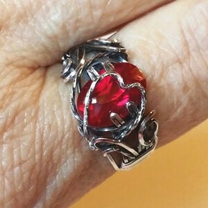 Beautiful Lab created ruby, 12x8mm, is wrapped in sterling silver with antique patina. Prong setting has heart motif in silver. Size 9 1/2 image 1