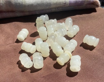 Bargain supply offering 22 carved quartz beads.  pools drilled lengthwise.  beads are 20mm long by 12mm cylindrical girth.