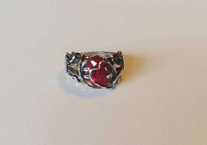 Beautiful Lab created ruby, 12x8mm, is wrapped in sterling silver with antique patina. Prong setting has heart motif in silver. Size 9 1/2 image 4