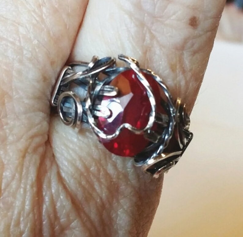 Beautiful Lab created ruby, 12x8mm, is wrapped in sterling silver with antique patina. Prong setting has heart motif in silver. Size 9 1/2 image 5