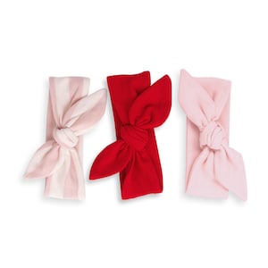 May include: Three knotted headbands in pink, red, and pink and white stripes.