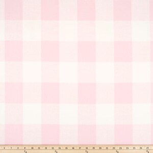 May include: Pink and white gingham fabric with a white measuring tape.