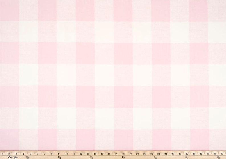May include: Pink and white gingham fabric with a white measuring tape.
