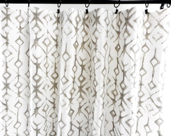 May include: White curtains with a brown geometric pattern. The pattern is a repeating diamond shape with a vertical line in the center.