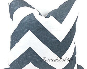 May include: A gray and white chevron patterned throw pillow. The pillow is made of a soft, textured fabric. The pillow is perfect for adding a touch of style to any room.