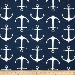 May include: Navy blue fabric with a repeating pattern of white anchors. The anchors are evenly spaced across the fabric, creating a nautical theme. The fabric has a subtle texture, adding depth to the design.