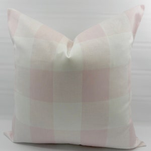 May include: A pink and white gingham pillow cover. The pillow cover is made of a soft, woven fabric and has a subtle sheen.