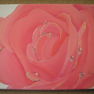 May include: Close-up of a pink rose painting with water droplets. The petals are a soft pink with yellow highlights. The painting is on a white canvas.