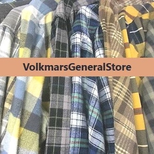 May include: A white ceramic mug with a black handle and the text "But First, Coffee" in a black, handwritten-style font. The mug is on a white surface.