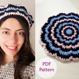May include: A crochet beret with black, pink, and blue stripes. The beret is shown on a person's head. The image also shows a close-up of the crochet pattern, which is a circular design with black, pink, and blue stripes. The text "PDF Pattern" is written in purple on a white background.