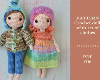 May include: Crochet pattern for two dolls with a set of clothes. The dolls are wearing a blue and green striped sweater, blue pants, a pink and purple striped dress, and a pink hat. The pattern is available as a PDF file.