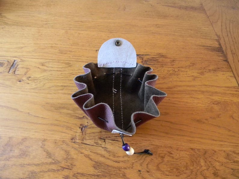 Two-coloured leather bursary binds wine and handmade white