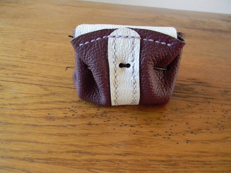 Two-coloured leather bursary binds wine and handmade white