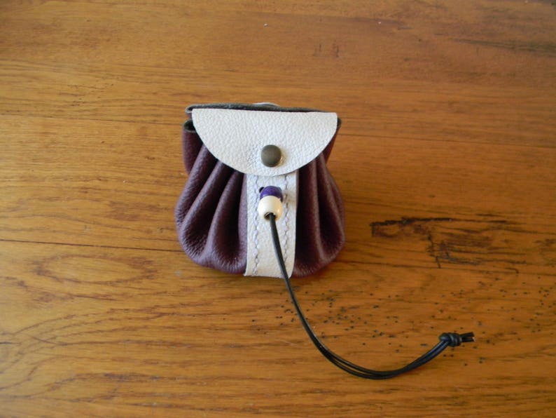 Two-coloured leather bursary binds wine and handmade white