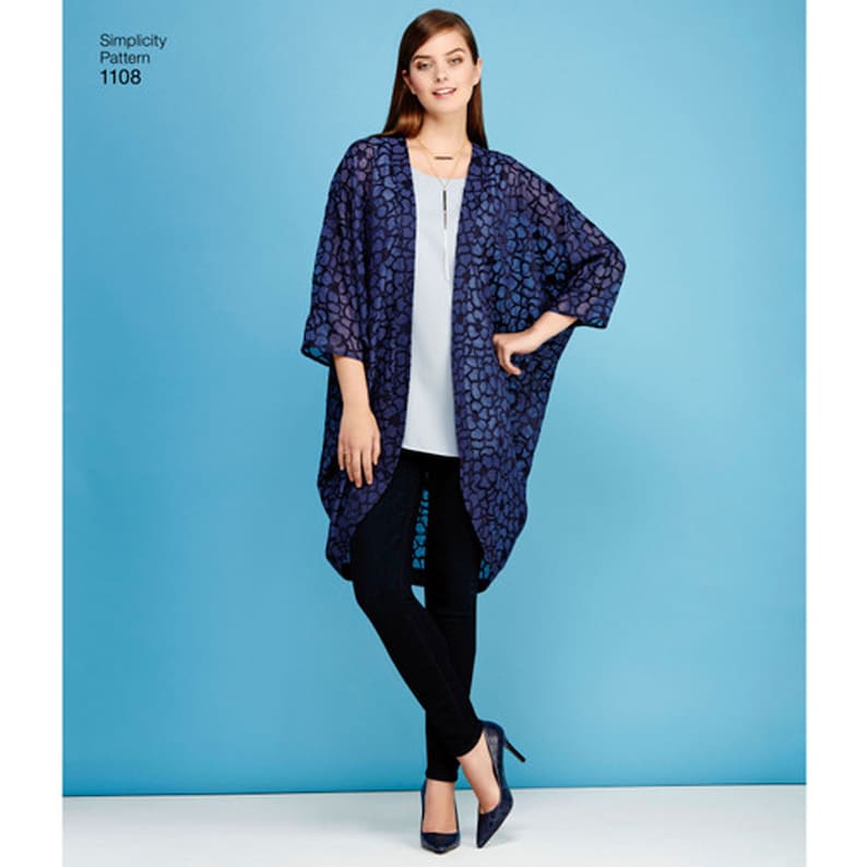 May include: Simplicity Pattern 1108 features a loose-fitting, open-front kimono-style cardigan with three-quarter length sleeves. The garment is made of a dark blue, semi-sheer fabric with a textured, repeating organic pattern throughout the design.