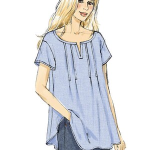 May include: Illustration of a pale blue short-sleeved tunic top with a split neckline and vertical pleats. The top is paired with dark blue jeans. The drawing is of a woman with long blonde hair.