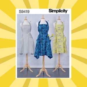 May include: Simplicity pattern S9419 features three aprons on dress forms. The aprons are displayed in gray, blue, and yellow. The gray apron has white trim and pockets. The blue apron has a floral pattern. The yellow apron has a floral pattern.
