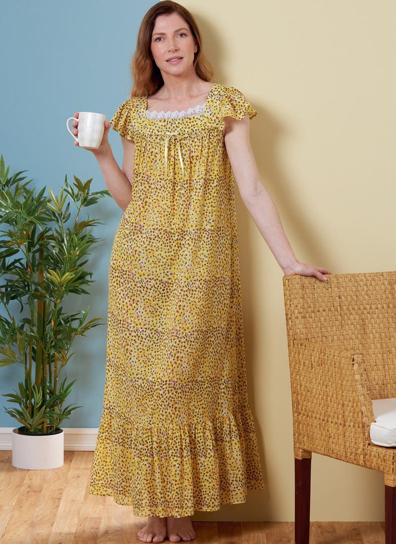 May include: A long, yellow nightdress with a small, dark pattern. The nightdress features short sleeves, a square neckline with lace trim, and a ruffled hem. A woman holds a white mug. The background is a mix of blue and yellow.