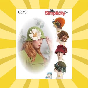 May include: Simplicity pattern 8573 features several vintage-style cloche hats. The hats are displayed in various colors, including green, orange, brown, and red, and are adorned with floral embellishments. The image includes the Simplicity logo.