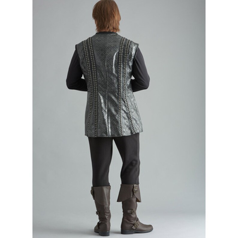 May include: A costume ensemble featuring a textured, silver-grey vest with vertical beaded accents, worn over a black long-sleeved shirt. The outfit includes black trousers and brown leather boots with buckles. The overall look is reminiscent of historical or fantasy attire.