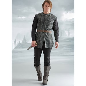 May include: A medieval costume comprising a grey vest with decorative stitching, a brown belt, a black long-sleeved shirt, black trousers, and grey boots. The costume includes a silver dagger. The outfit is designed for a historical or fantasy theme.